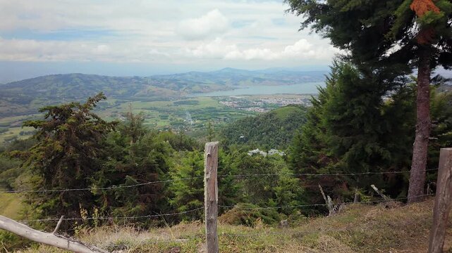 scenic view of colombia lake calima and mountain valley from behind fence