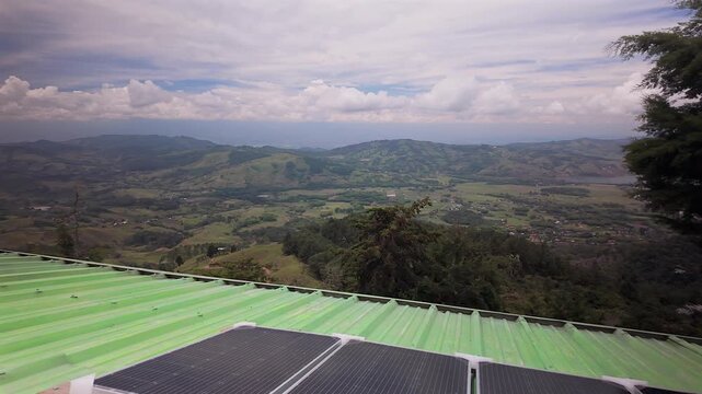 green metal roof with solar panels overlooking colombia mountain valley landscape