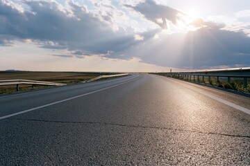 Obraz premium The Open Road Under Sun Rays on a Long Horizon Highway