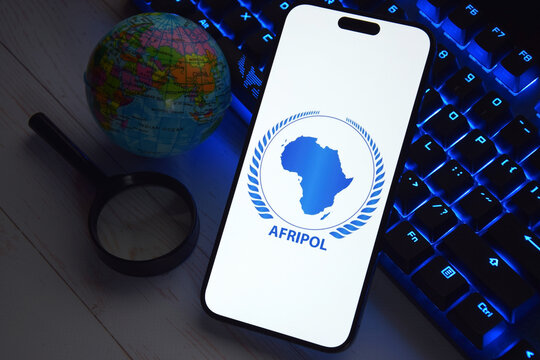 The smartphone with Interpol logo displayed on screen. International Criminal Police Organization or Interpol.
