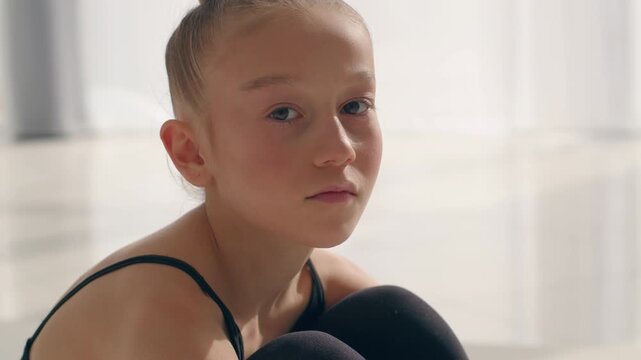 Sad pensive Caucasian little girl dancer gymnast looking at camera offended child frustrated adopted daughter alone lonely kid family custody offense female teenage schoolgirl orphan problem childcare
