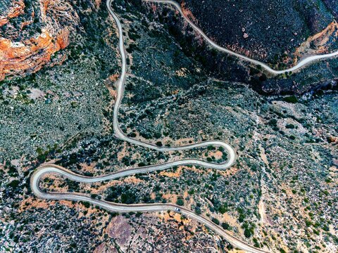 Aerial view of mountain pass with dirt road