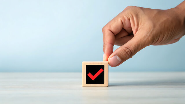 Hand placing wooden block with red down arrow symbol on light surface for business concept