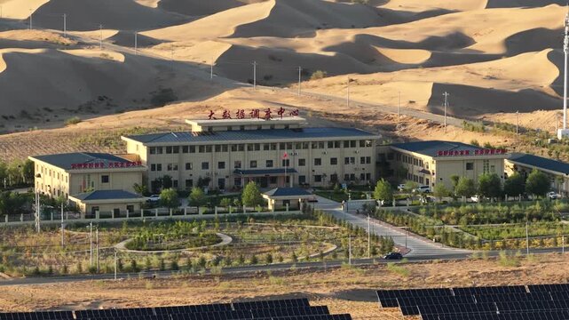 Modern Big Data Center Building Amidst Majestic Sand Dunes in Western China Desert