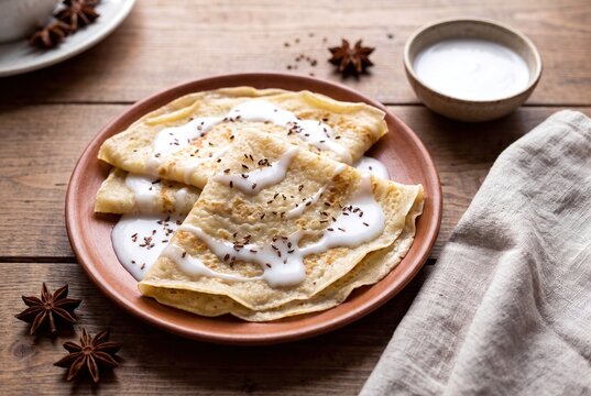 Somali Malawah Crepes Served with Sweet Coconut Milk and Fragrant Anise on a Clay Plate