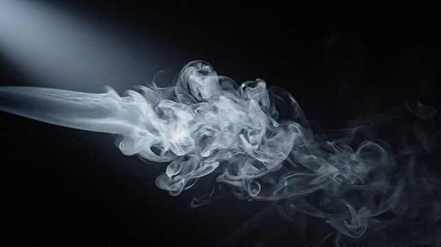 White smoke plume billowing and curling through a dark space. Dramatic vapor movement and fluid dynamics concept for atmospheric background design.