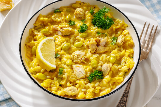 Creamy saffron chicken risotto in a bowl, close-up