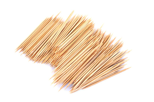 A pile of natural wooden toothpicks arranged on a clean white background, highlighting their pointed tips, lightweight design, and everyday use for food preparation and hygiene.
