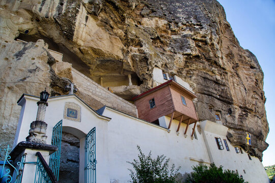 A monastery in a rock on a clear, sunny day. Nature, landscape, world tourism.