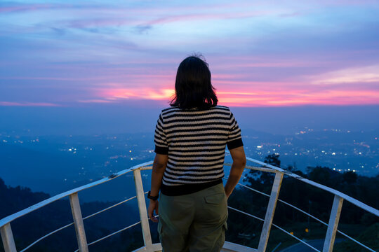 Rear view of woman looking at sunset at Bukit Kokol Kota Kinabalu Sabah Malaysia