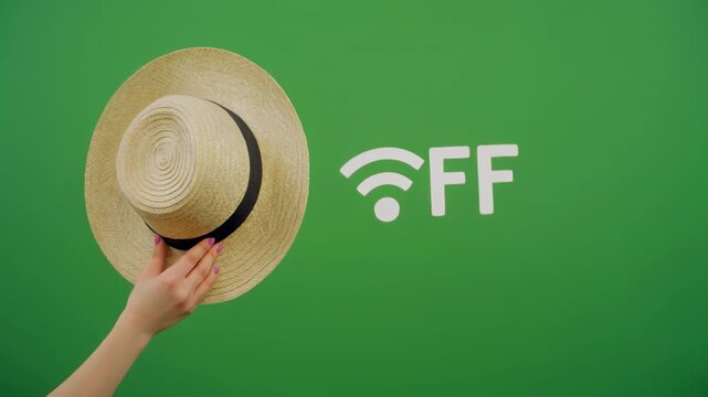 Straw hat waving with wifi symbol turning off against vivid green background cinematic motion