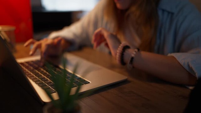 Teenage girl studying at a computer at home while preparing for a new school year. Back to school, education, homework, digital learning and student preparation concept.