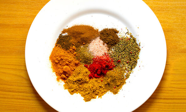 Fresh ground colourful background spices on ceramic plate