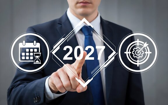 Businessman pointing at 2027 year concept with planning and target icons