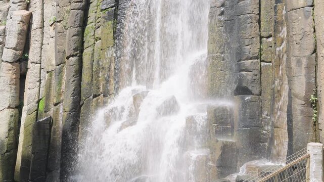 Powerful waterfall cascading down the impressive basaltic prism rock formations in huasca, mexico
