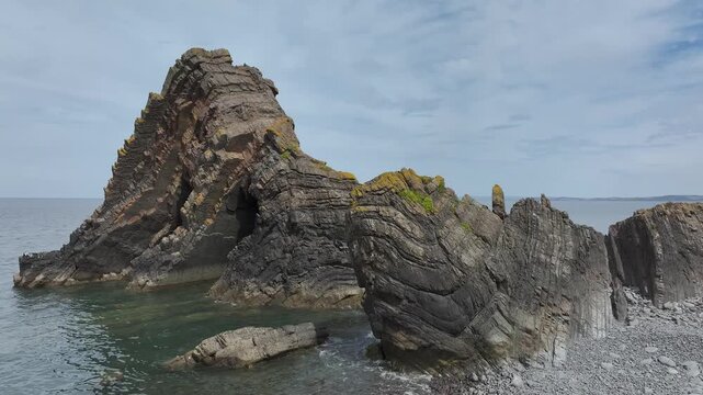 Blackchurch Rock and Cliffs over Mouthmill Beach from a drone, North Devon Coast, Devon, England