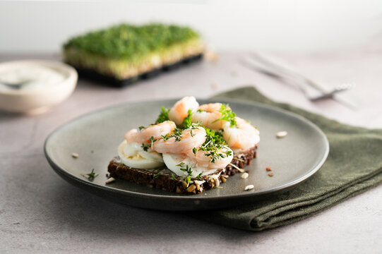 Healthy Scandinavian smorrebrod with seafood and egg.
