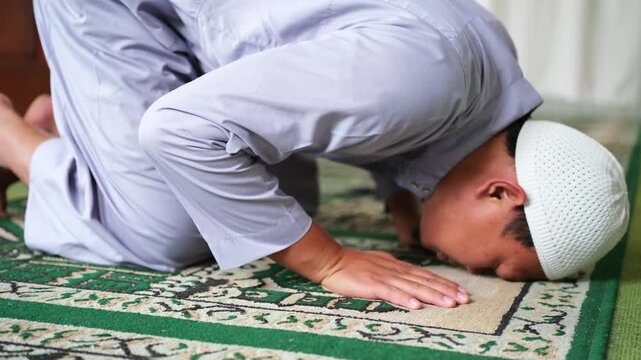 Closeup of head position when prostrating in prayer. Prostration movement in prayer. The form of humbled oneself to God. Muslim worship.