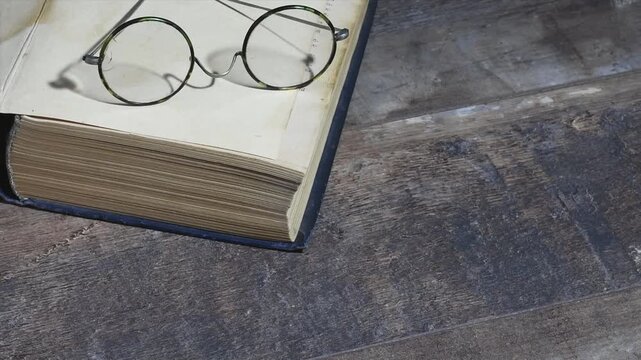 Take the old glasses and close the vintage book in the morning at dawn