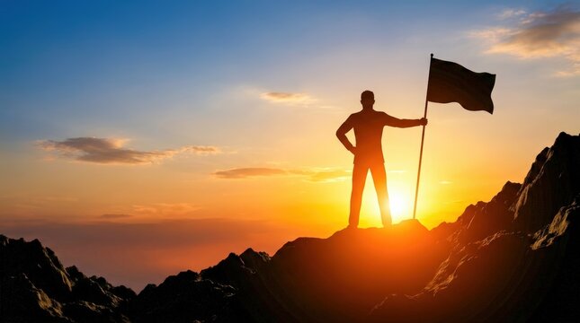 Silhouette of a man holding a flag on a mountain peak at sunset symbolizing achievement and success.