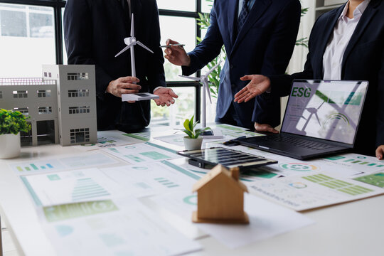 Business team discussing esg strategies, investing in sustainable energy and green technology projects