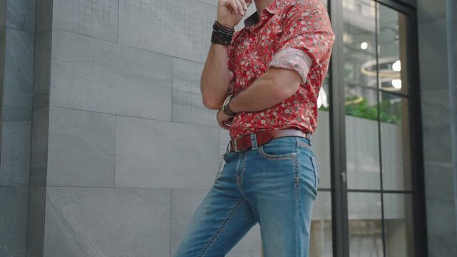 Stylish mature man with glasses, beard, and patterned shirt standing in a modern interior, representing confidence, individuality, fashion, professional lifestyle, and contemporary menswear.

