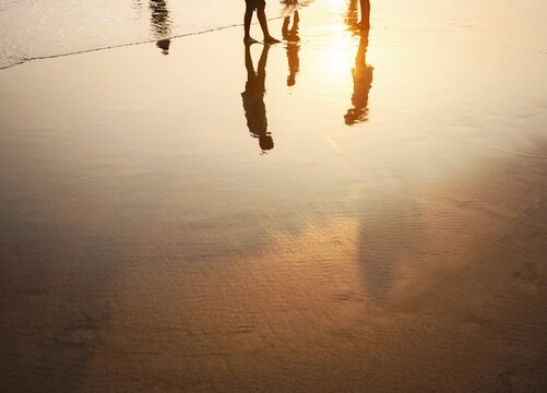 Silhouette reflection Family on beach sand during sunset concept of happy family lifestyle Father's day Mother's day