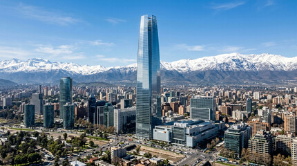 Fototapeta premium Modern Skyscraper Cityscape with Snow-Capped Andes Mountains in Background