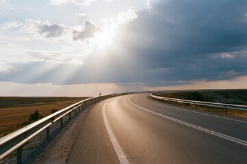 Obraz premium The Open Road Ahead A Serene Winding Highway Bathed in Golden Sunlight