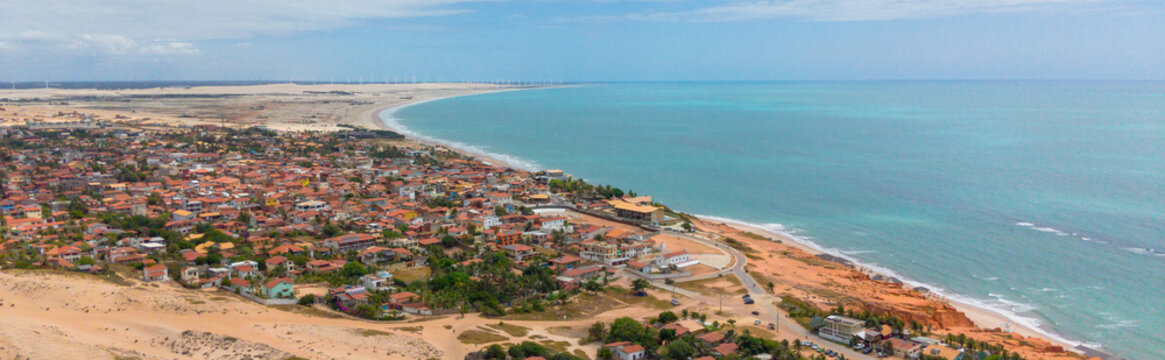 Aerial Panorama of Canoa Quebrada with Church and Beachfront Cliffs, Ceara