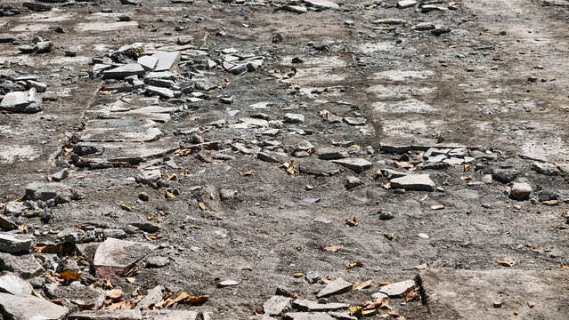 Concrete rubble and fragments scattered on a demolition site, showing destruction, construction waste, and abandoned ground after building removal