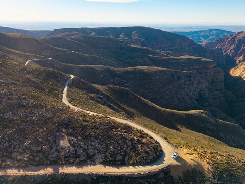 Aerial of winding dirt road mountain pass, Swartberg pass, South Africa