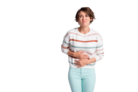 Photo of sad young lady wear striped sweater arms tummy having period looking empty space isolated grey color background