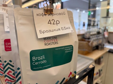 Minsk, Belarus - August 04, 2026: Coffee package labeled Brazil Cerrado blend is showcased in a cafe with a price tag and branding from Marconi Coffee Roasters