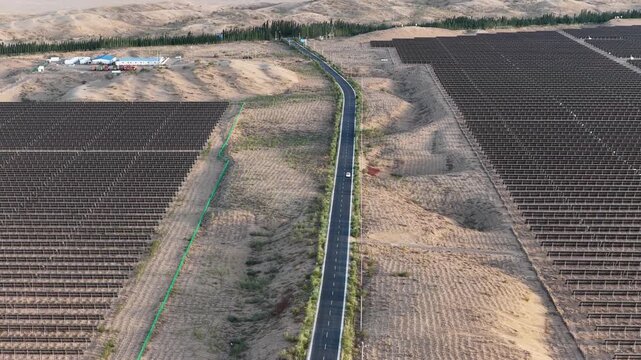Aerial View of Highway Dividing Large Solar Farm Panels in the Gobi Desert of Northwest China