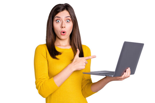 Photo of impressed brunette nice lady hold point laptop wear yellow sweater isolated on grey color background