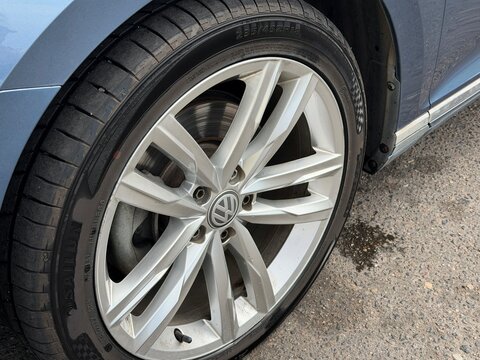Vitsebsk, Belarus - August 05, 2026: Close-up view of a Volkswagen car wheel featuring a silver alloy rim and black tire on an asphalt surface