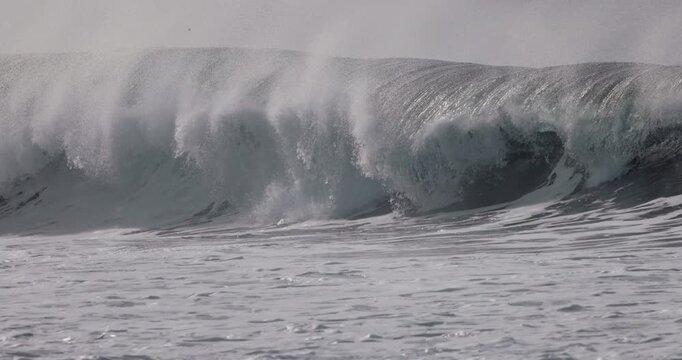 Powerful ocean wave crashing in ocean. Slow motion on storm waves