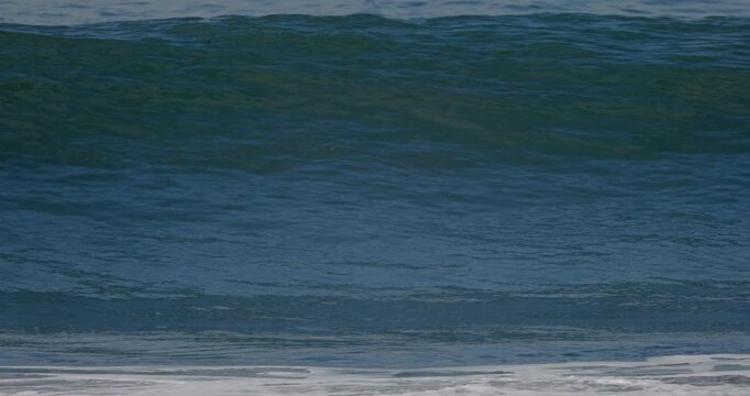 Powerful ocean wave crashing in ocean. Slow motion