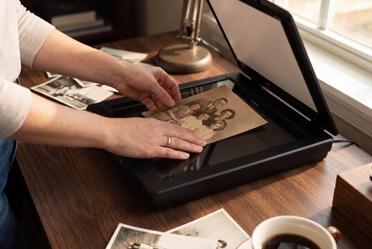 Scanning old family photographs on flatbed scanner for digital archive