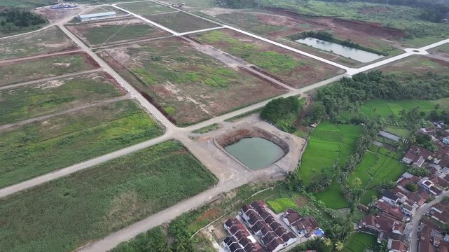 Aerial drone view of land development real estate site with housing plots and roads