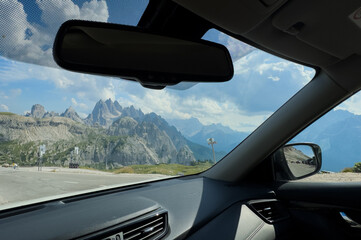 Obraz premium Mountains mirror on a road at sunset, concept of travel, journey, and looking back at the past. 