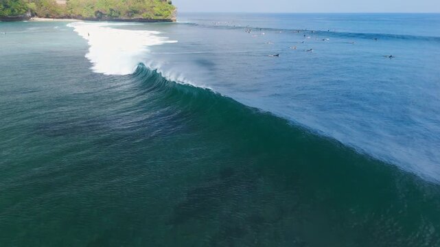 Aerial view with ocean waves and surfers in ocean on Balangan beach. Surfing and waves
