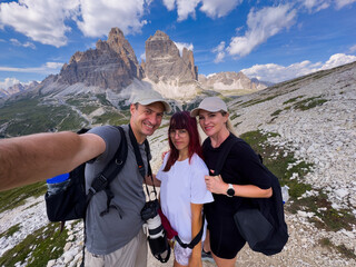 Fototapeta premium Holiday, mountain and portrait of family with smile, nature and outdoor bonding together on travel adventure. Mom, dad and child on summer vacation with hiking, happy face and sunshine on hill
