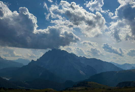 Majestic scenery of rough mountain ridge near grassy hills Tre Cime, Dolomites Italy