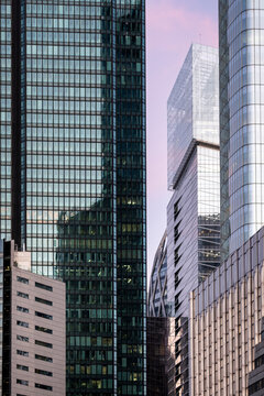 In La Defense, Paris, France, a dense cluster of glass office towers layers the urban skyline, where each facade and line of architecture catches evening light.