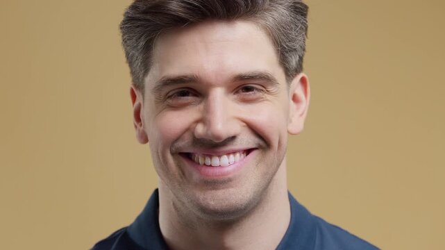 Close Up Portrait Of Handsome 35 Year Old Brunette Man With Slight Gray Hair, Warm Kind Smile And Natural European or American Appearance, Mature Male Lifestyle And Beauty Concept