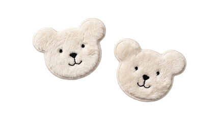 Two fluffy teddy bear face embroidered plush patches on a transparent background © Vitalo4ok