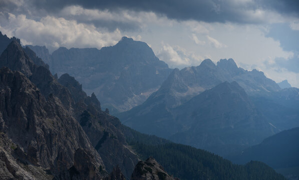 Majestic scenery of rough mountain ridge near grassy hills Tre Cime, Dolomites Italy
