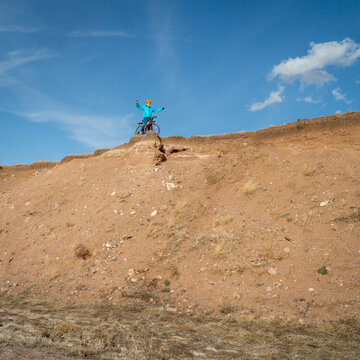 male cyclist is riding a gravel bike on cliff edge in Colorado prairie - Soapstone Prairie Natural Area